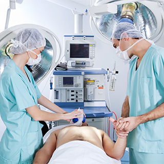 anasthesiologists putting a person under at the start of a procedure