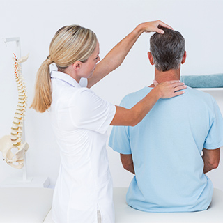 physician helping adjust a person's neck