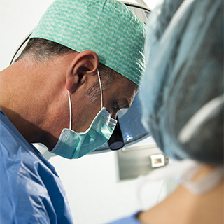 face of a surgeon operating on a patient