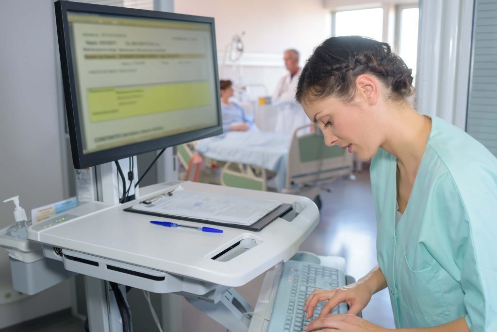 nurse working with patient files, medical practitioner using medical software